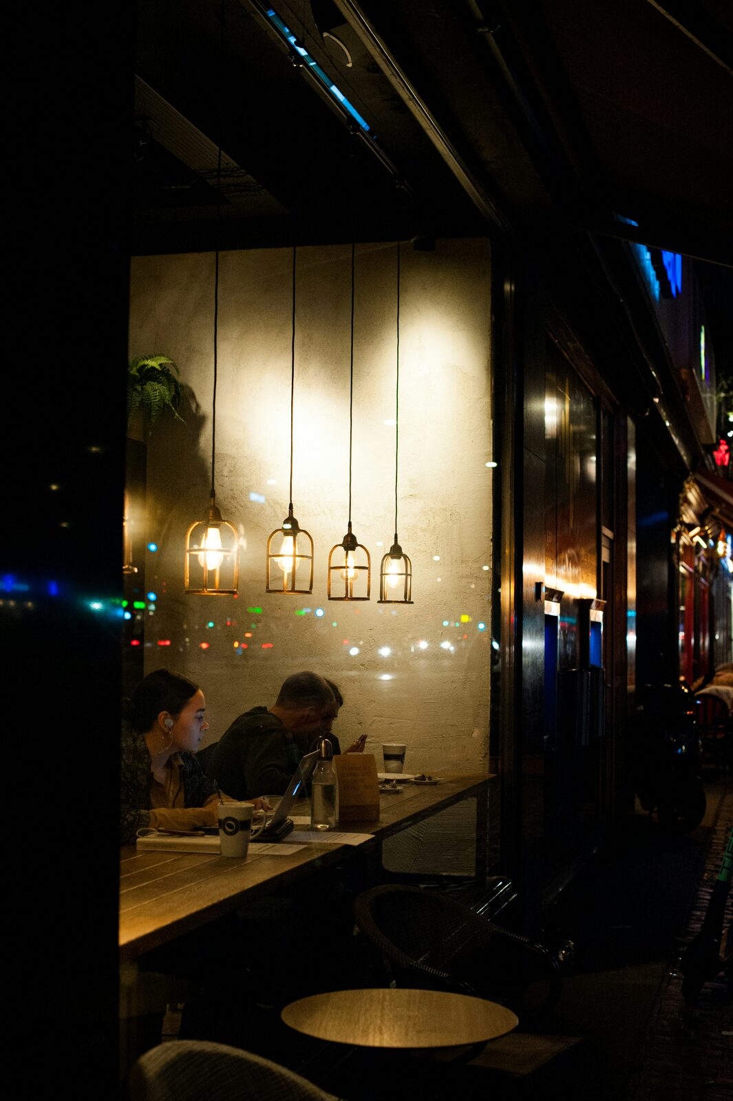 Guests seated inside a warmly lit café at night